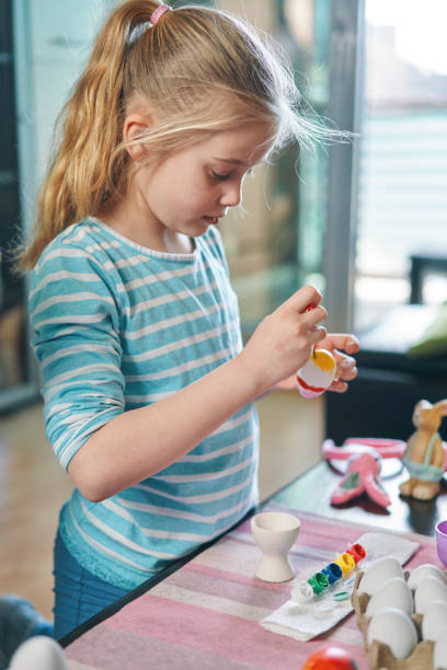 Little Girl Painting Easter Eggs