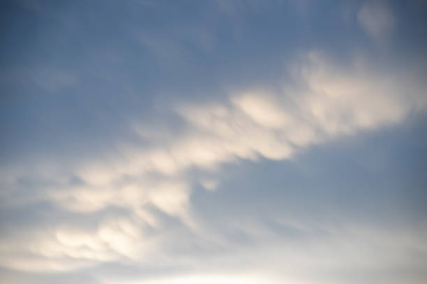 istock natural moving white cloud on blue sky in evening.  strange cloud movement background. 1204982320