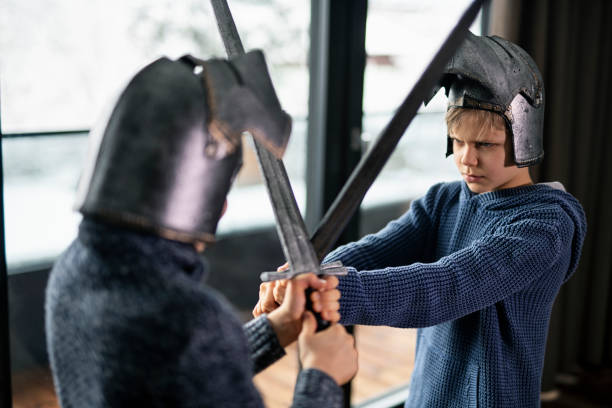 istock Little boys playing knights at home 1204984143