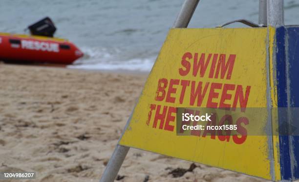 Notice On The Beach To Swim Between The Flags In Australia Stock Photo - Download Image Now