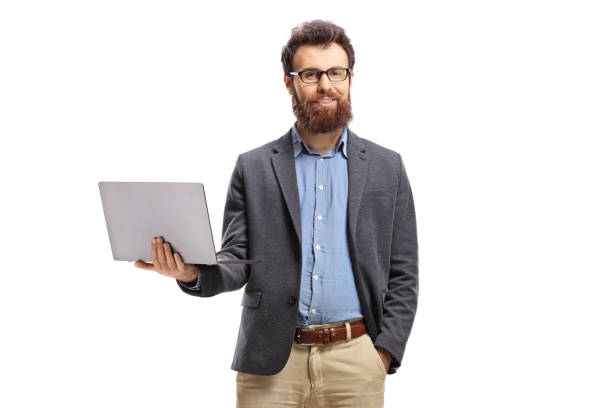 istock Bearded man standing with a laptop and smiling at the camera 1204986667