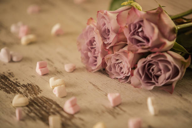 istock Delicate bouquet of roses and heart shaped candy 1204988500