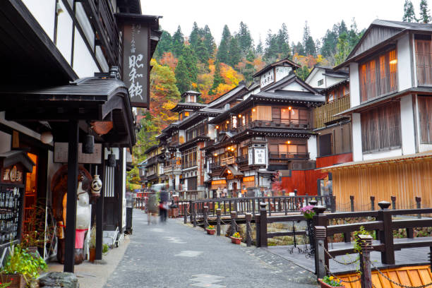 Ginzan onsen at autumn, Yamagata, Tohoku, Japan Many tourists come to this village in autumn for fall foliage scene with the ancient town. miyazaki prefecture stock pictures, royalty-free photos & images