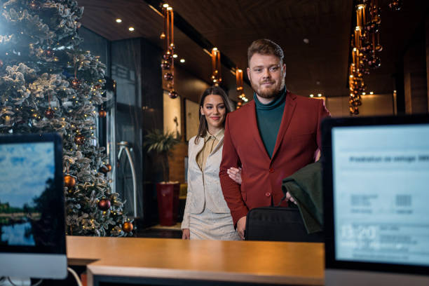 istock Handsome young business couple arriving at a hotel reception 1204991151