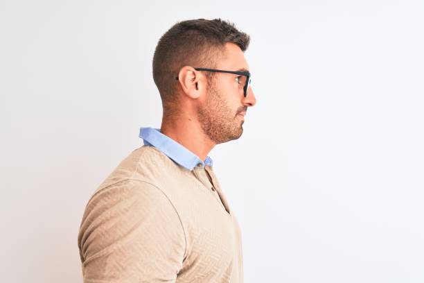istock Young handsome man wearing glasses over isolated background looking to side, relax profile pose with natural face with confident smile. 1204994742