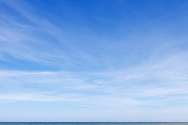 istock Beautiful blue sky over the sea with translucent, white, Cirrus clouds 1204995913
