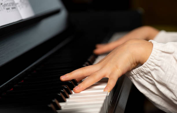 istock Little Girl Playing the Piano 1204995956