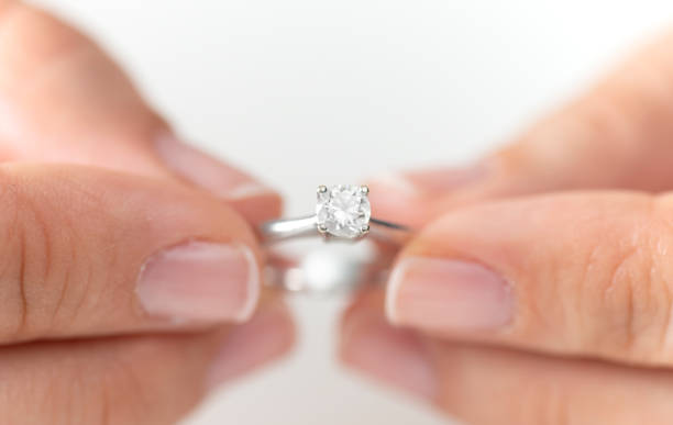 istock Woman Holding a Diamond Ring 1204996620