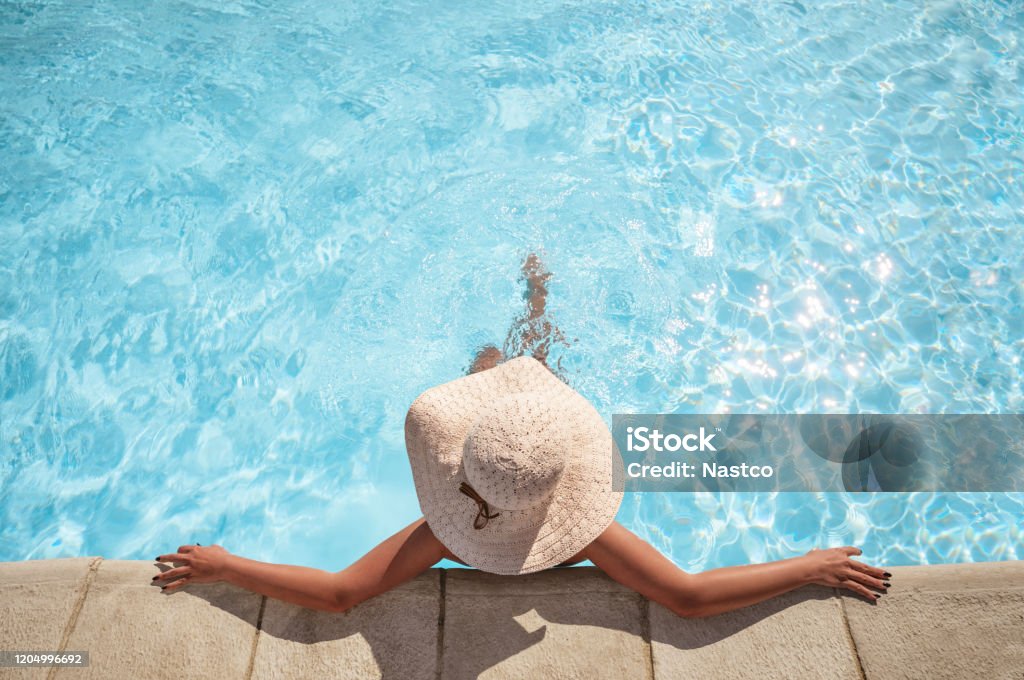 Young woman relaxing in the swimming pool Young woman relaxing in the swimming pool with copy space Swimming Pool Stock Photo