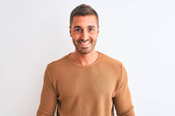 istock Young handsome elegant man wearing winter sweater over isolated background with a happy and cool smile on face. Lucky person. 1204996703
