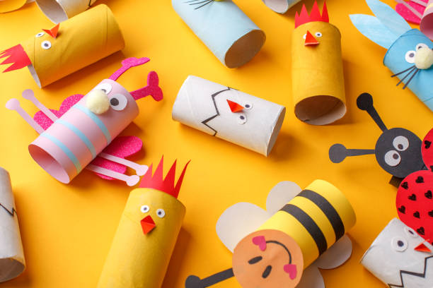 istock Happy easter kindergarten decoration concept - rabbit, chicken, egg, bee from toilet paper roll tube. Simple diy creative idea. Eco-friendly reuse recycle decor, daycare paper craft 1204998044