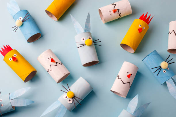 istock Happy easter kindergarten decoration concept - rabbit, chicken, egg, bee from toilet paper roll tube. Simple diy creative idea. Eco-friendly reuse recycle decor, daycare paper craft 1204998053