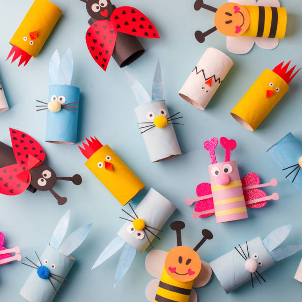 istock Happy easter kindergarten decoration concept - rabbit, chicken, egg, bee from toilet paper roll tube. Simple diy creative idea. Eco-friendly reuse recycle decor, daycare paper craft 1204998079