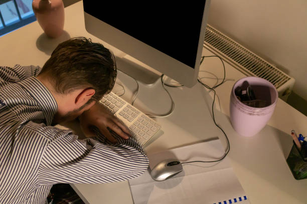 istock Above view of entrepreneur resting on office desk while working late. 1204998937