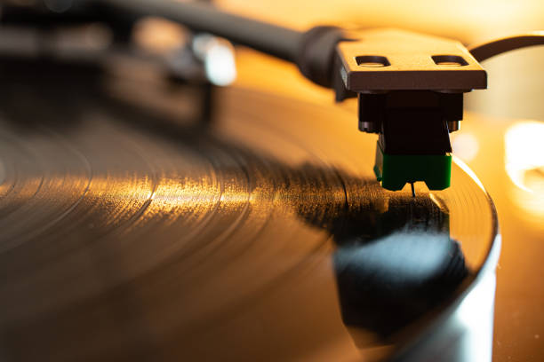 A close up macro shot of the needle through the grooves of a record on a turntable. A close up macro shot of the needle through the grooves of a record on a turntable. berkel stock pictures, royalty-free photos & images