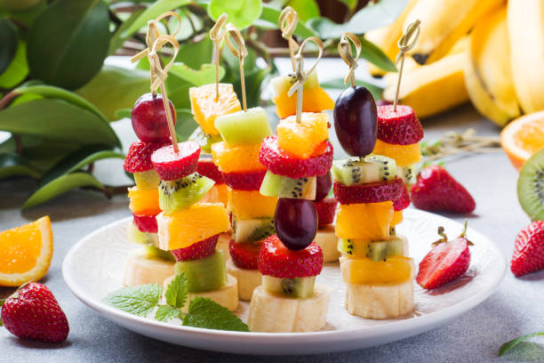 istock Fresh fruit on skewers. Concept buffet for a summer party. 1205001020