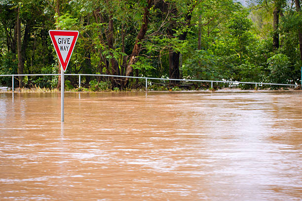 istock Very flooded road and give way sign 120500143