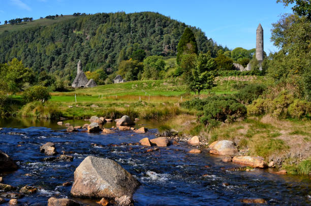 istock landscape with river and celtic round tower Glendalough 1205005725