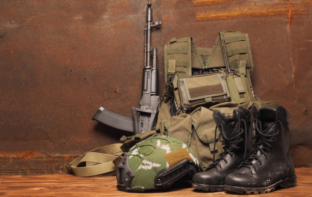 istock Concept - service, security, Armed Forces, Private military company, navy, mercenary. Weapons, helmet, cleats, body armor on a rustic background. 1205006681