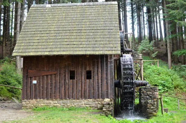old wooden water mill with mill-wheel detail photo