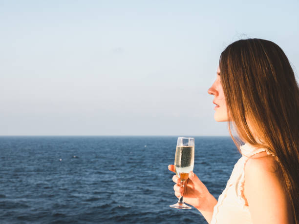 istock Woman holding a glass on the deck 1205008697