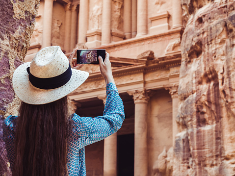 Fashionable woman, exploring the sights of the ancient, fabulous city of Petra in Jordan. Colorful photos. Concept of leisure, vacation and travel