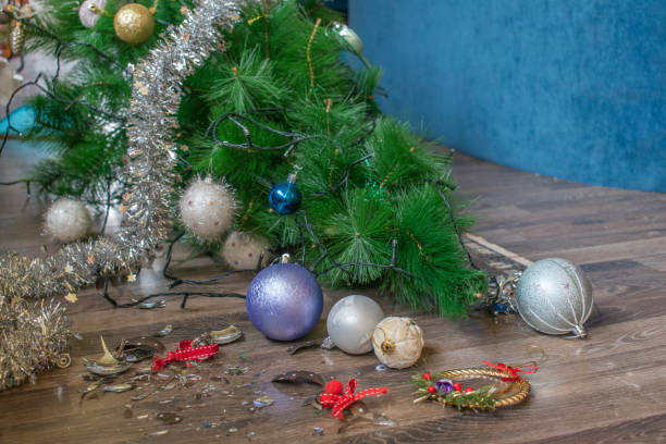 istock Broken christmas bauble near fallen christmas tree 1205009932