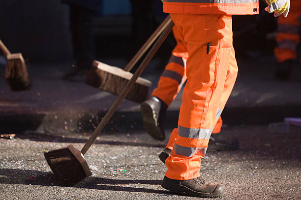 Street cleaner Street cleaners sweeping am confetti in street street sweeper stock pictures, royalty-free photos & images
