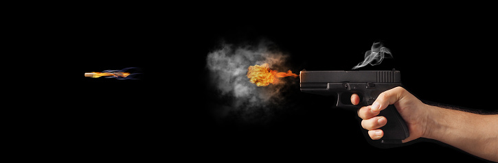 concept of freezing shot of a gun on a dark background . Concept gun club, gun-shop, shooting range.