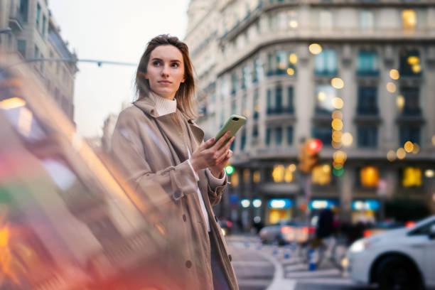 istock Young woman with smartphone on night street 1205011301