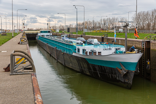 Maasbracht, The Netherlands - March 20, 2019: Big barge in lock of canal Julianakanaal near river Meuse in Dutch Limburg