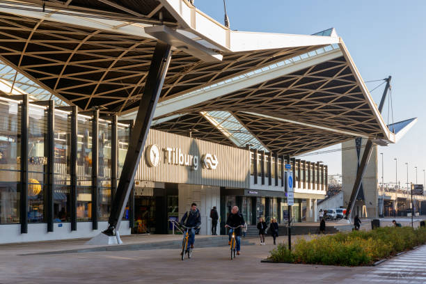 Tilburg, The Netherlands - December 04, 2019: Railway station Tilburg with passing cyclists and pedestrians