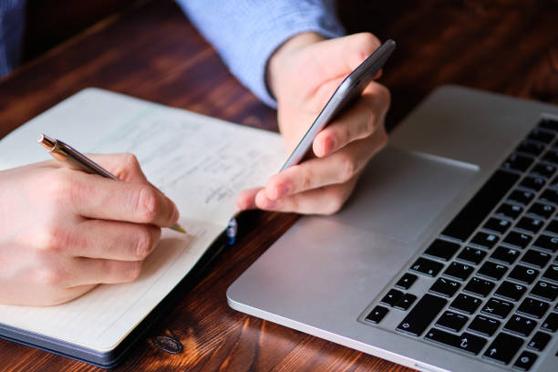 istock A man makes diary entries from a smartphone. Business concept. 1205013137