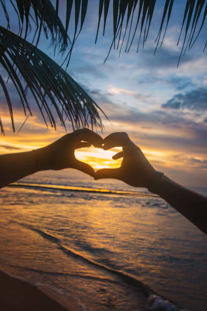 istock A girl and a man make hands a heart at sunset. Sri Lanka. Selective focus. 1205013249
