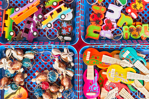 Boracay, Aklan Province, Philippines - June 6, 2019: Array of colorful key chain souvenirs for sale in four baskets, viewed from above