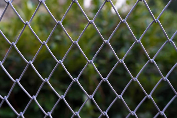 istock Steel fence with green background. 1205023245