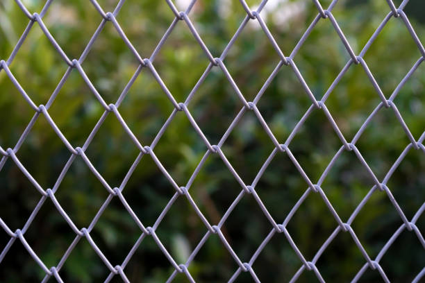 istock Gray steel net with green background. 1205023246