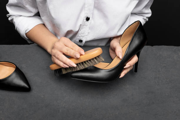 polishing shoes. woman hands cleaning shoes close up. polishing shoes. woman hands cleaning shoes close up. shoe polish stock pictures, royalty-free photos & images