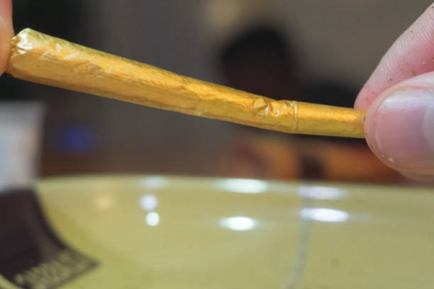 istock Make cigar from marijuana. Hemp in smoking paper. 1205026669