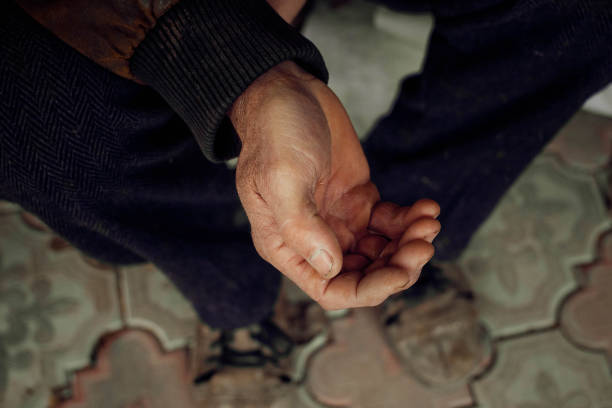 istock Close up extended arm of an elderly man asking for help or money. 1205028981