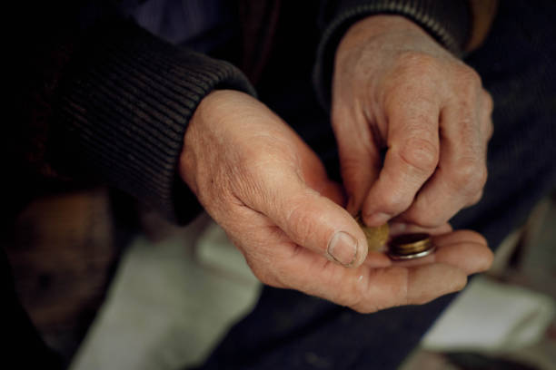 The hands of an elderly man consider small things. The hands of an elderly man consider small things. Concept of poverty and low pensions. begging social issue photos stock pictures, royalty-free photos & images