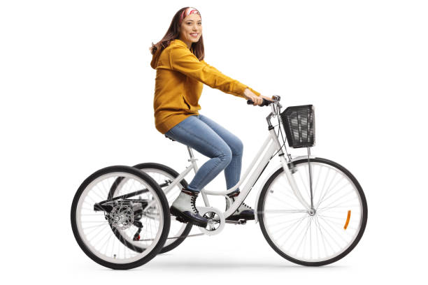 istock Young female riding a white tricycle and looking at the camera 1205029890