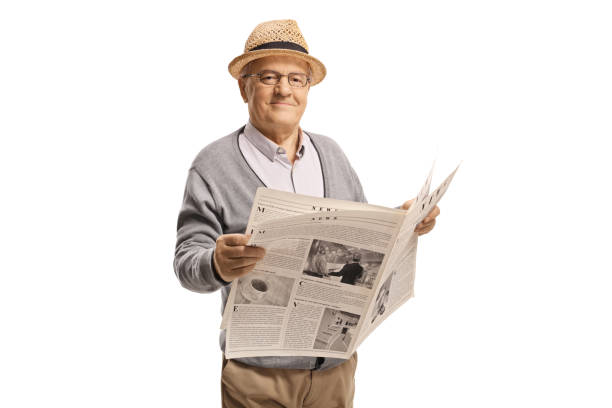 istock Mature gentleman holding a newspaper and smiling 1205030055