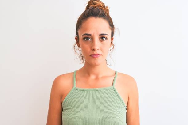istock Young redhead woman wearing a bun over isolated background with serious expression on face. Simple and natural looking at the camera. 1205030284