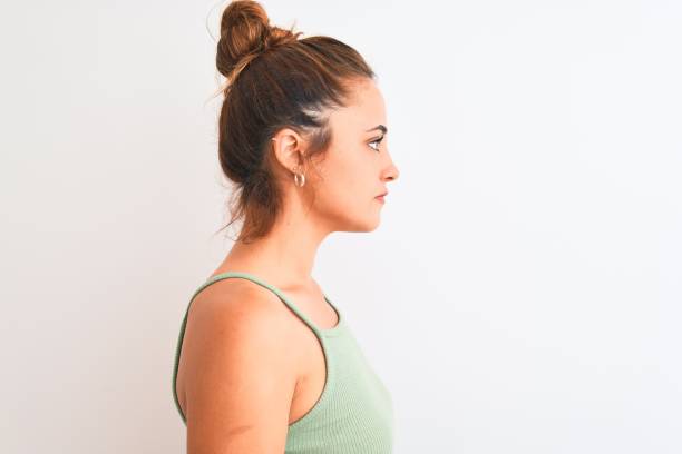 istock Young redhead woman wearing a bun over isolated background looking to side, relax profile pose with natural face with confident smile. 1205030302
