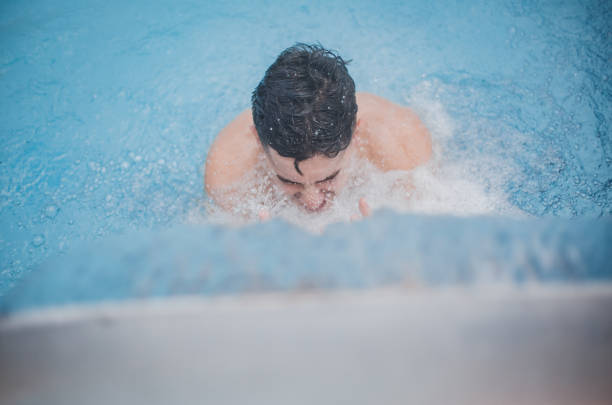 Splashes of water in the swimming pool, closeup of photo