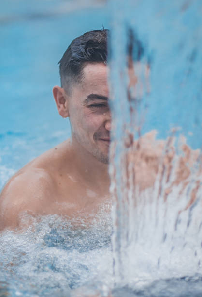 istock Young man in the pool at the spa 1205030515
