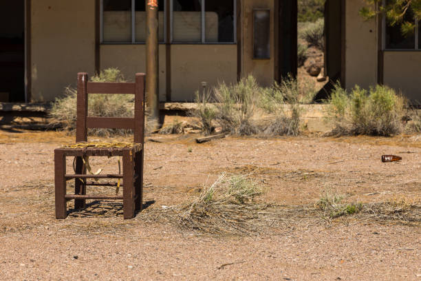 Abandoned, destroyed buildings at 6 road. Old, damaged chair in front of the house. Ghost town, Inyo National Forest. Nevada, USA