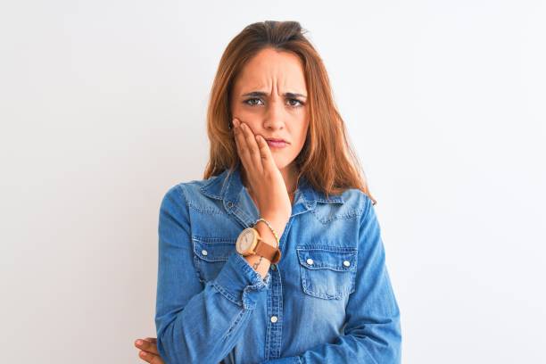 istock Young redhead woman wearing denim jacket standing over isolated background thinking looking tired and bored with depression problems with crossed arms. 1205031273