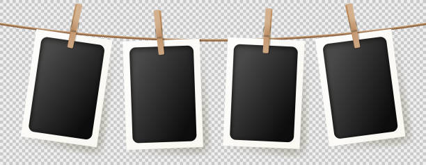 Realistic retro photo frames Realistic retro photo frames. Vector illustration with blank photo cards hanging on rope. Mockup concept isolated on transparent background. clothesline photos stock illustrations